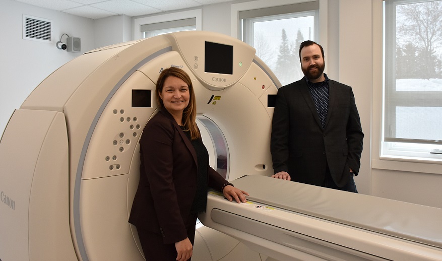 President & CEO Lynne Innes with VP Eric Theriault stand in front of new CT machine